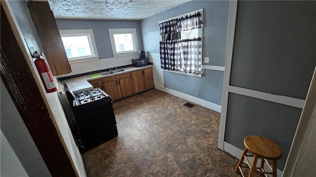 bathroom featuring sink and a textured ceiling