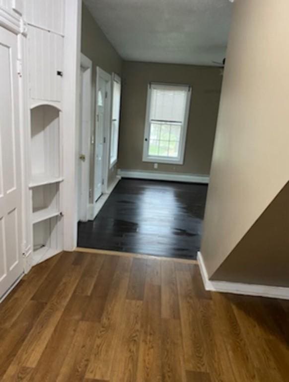 corridor featuring dark hardwood / wood-style floors