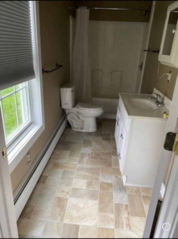 bathroom featuring vanity, a baseboard heating unit, walk in shower, and toilet