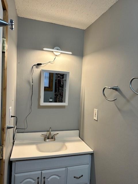 bathroom with vanity and a textured ceiling