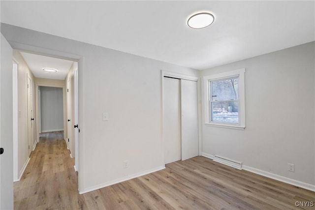 unfurnished bedroom with light hardwood / wood-style floors and a closet