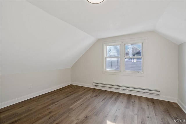 bonus room featuring hardwood / wood-style flooring, a baseboard radiator, and vaulted ceiling