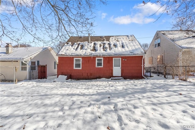 view of snow covered back of property