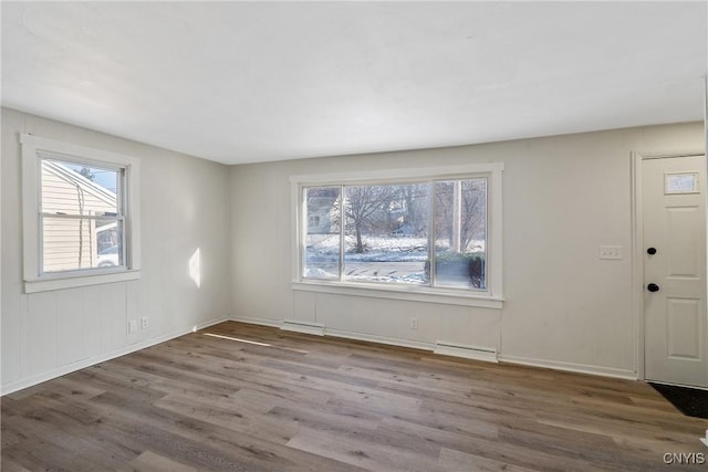 entryway featuring hardwood / wood-style flooring and a baseboard heating unit