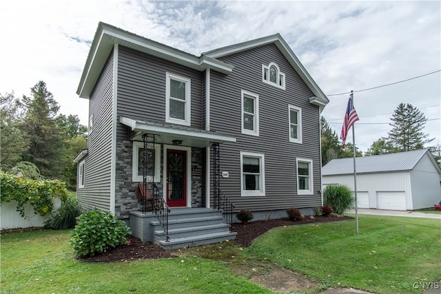 view of front of house with a garage, an outdoor structure, and a front lawn