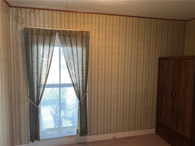 spare room featuring crown molding