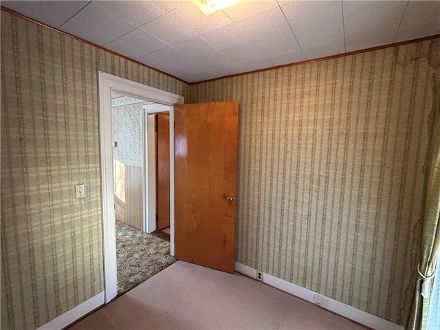 carpeted empty room featuring ornamental molding