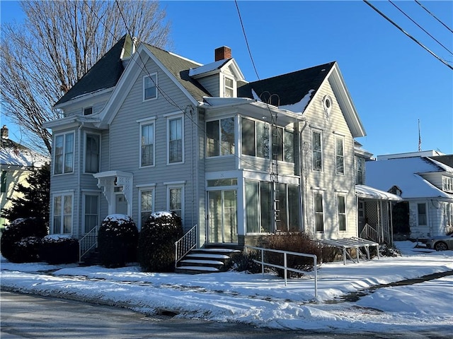 view of front of home with a sunroom