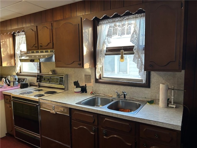 kitchen featuring tasteful backsplash, sink, and electric range