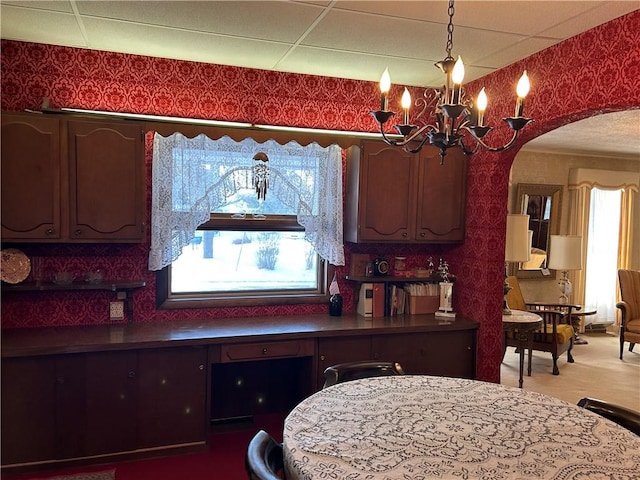 kitchen featuring pendant lighting and a chandelier