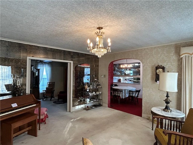 carpeted dining area with ornamental molding, a textured ceiling, and a chandelier