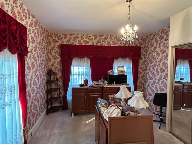 carpeted office featuring a chandelier