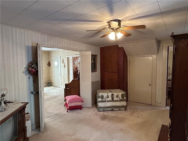 interior space featuring carpet floors and ceiling fan