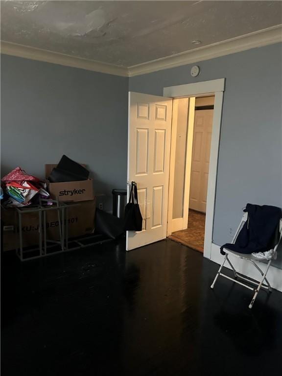 miscellaneous room with crown molding and dark wood-type flooring