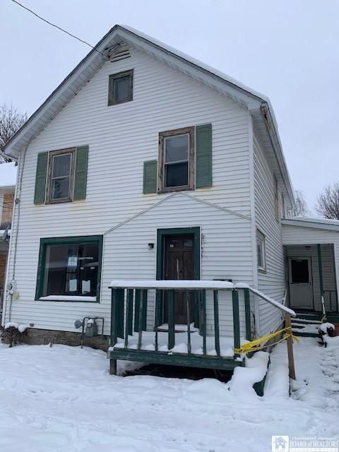 view of snow covered rear of property