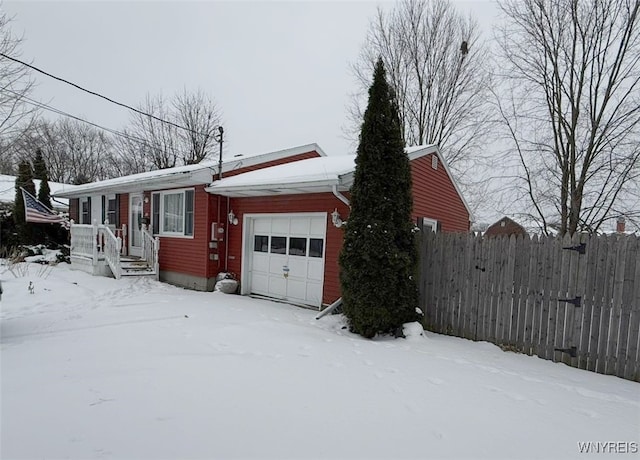 view of snow covered exterior featuring a garage