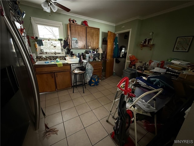 kitchen featuring sink, ornamental molding, fridge, and light tile patterned flooring