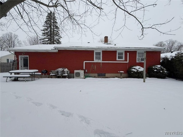 snow covered property featuring ac unit