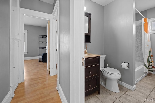 full bathroom with vanity, tile patterned floors, toilet, and shower / bath combo