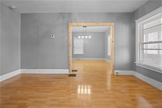 unfurnished room featuring light hardwood / wood-style floors