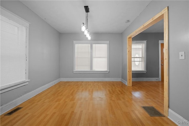 unfurnished dining area featuring light wood-type flooring