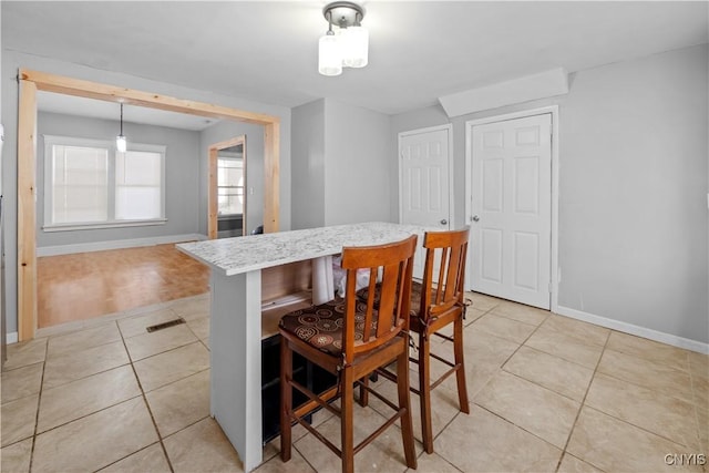 dining space featuring light tile patterned flooring