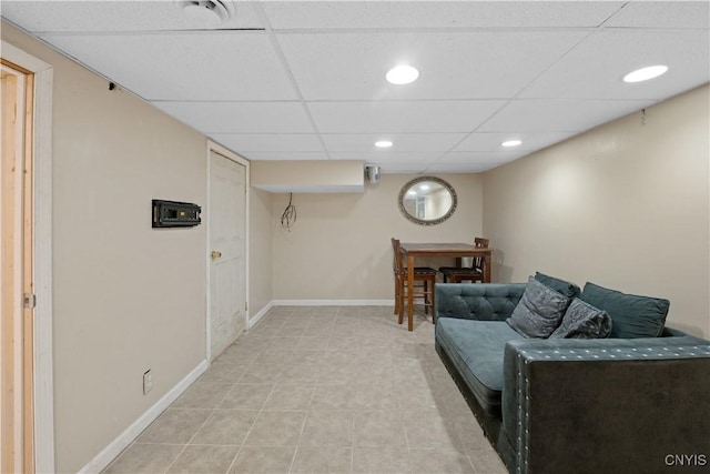 living room with a paneled ceiling