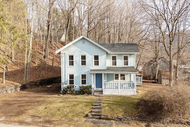 view of front property with covered porch and a front lawn