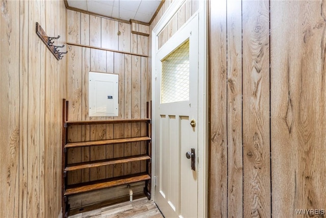 interior space featuring electric panel and wood walls