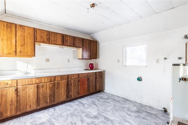 kitchen featuring vaulted ceiling and gas water heater