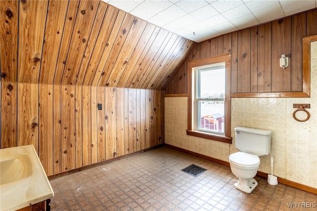 bathroom featuring vanity, vaulted ceiling, and toilet