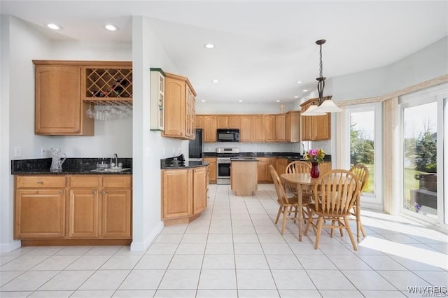 kitchen with sink, light tile patterned floors, black appliances, decorative light fixtures, and dark stone counters