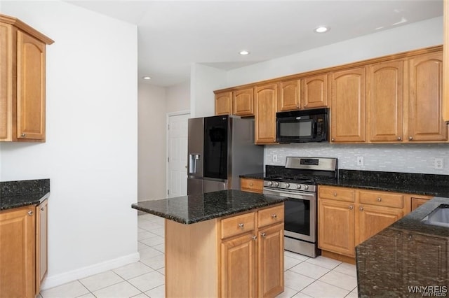 kitchen with tasteful backsplash, dark stone counters, light tile patterned floors, a kitchen island, and stainless steel appliances