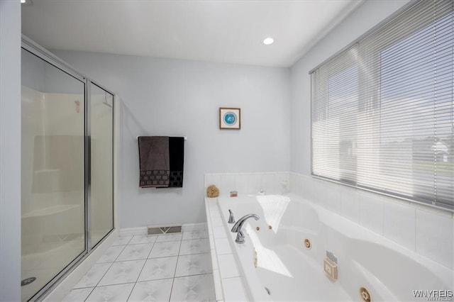 bathroom featuring independent shower and bath and tile patterned flooring