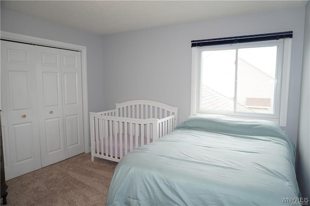 carpeted bedroom with a closet