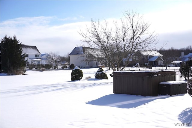 snowy yard with a hot tub