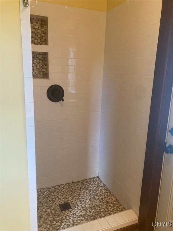 bathroom with a tile shower