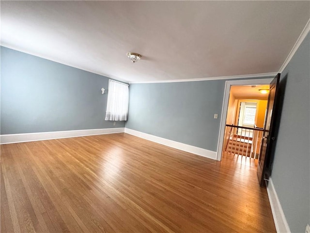 unfurnished room with crown molding and hardwood / wood-style floors