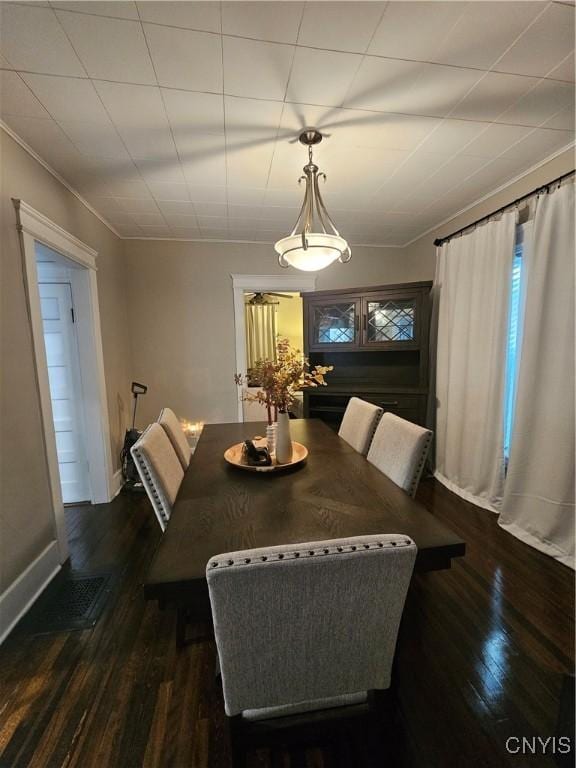 dining area featuring dark wood-type flooring