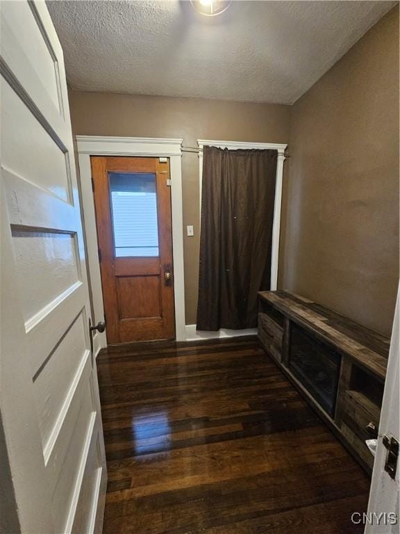 bathroom with hardwood / wood-style flooring and a textured ceiling