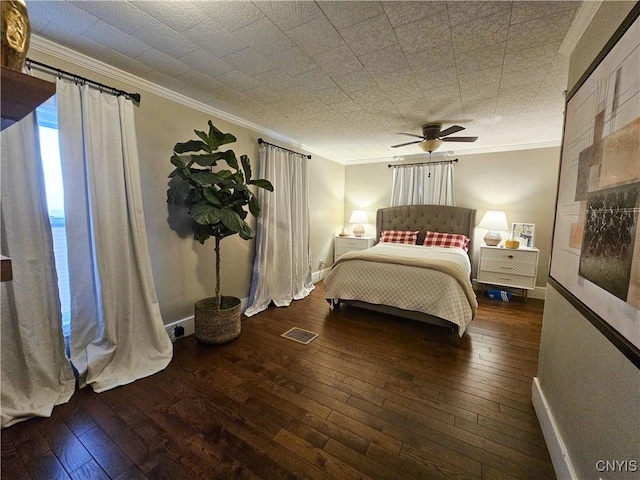 bedroom featuring ceiling fan, ornamental molding, and dark hardwood / wood-style floors