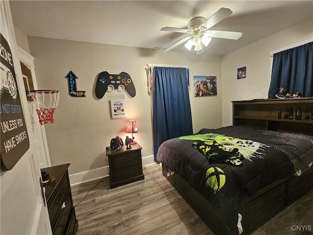 bedroom featuring hardwood / wood-style floors and ceiling fan