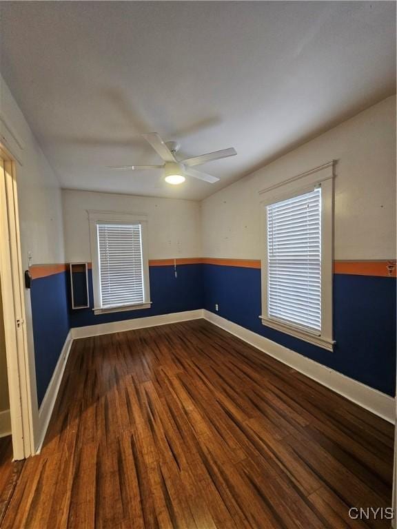 unfurnished room featuring dark hardwood / wood-style floors and ceiling fan