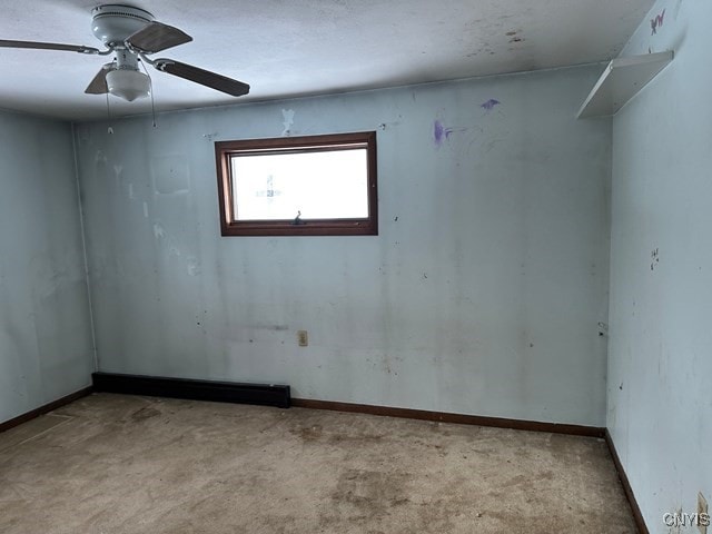 spare room featuring ceiling fan and light colored carpet