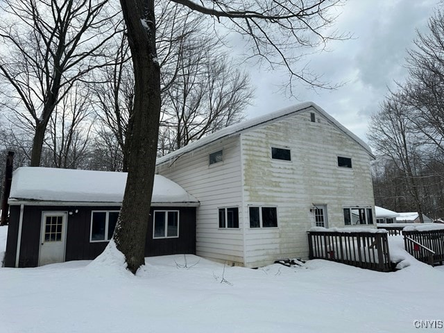 view of snow covered rear of property