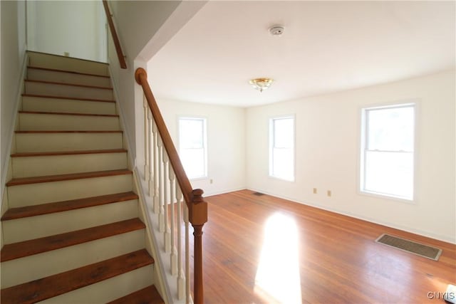 stairway featuring wood-type flooring