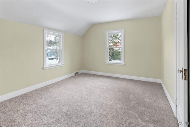 bonus room featuring plenty of natural light, carpet flooring, and lofted ceiling