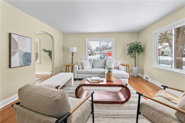 living room with plenty of natural light and hardwood / wood-style floors