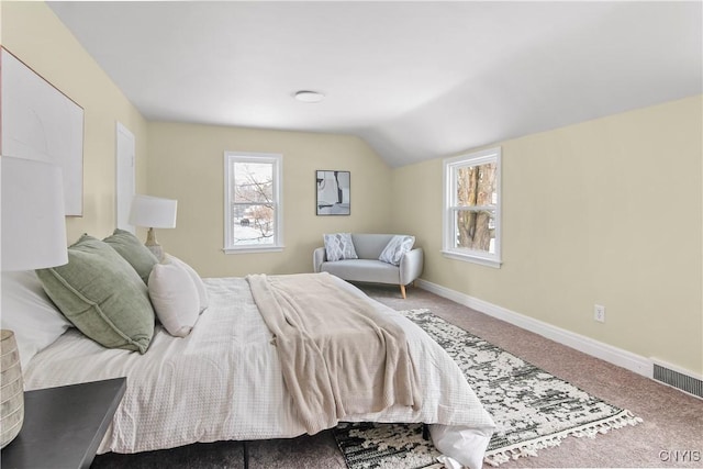 bedroom with carpet floors and vaulted ceiling