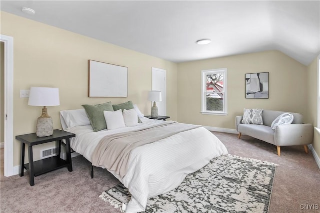 bedroom featuring light carpet and vaulted ceiling